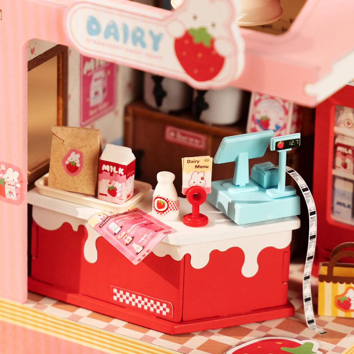 Mini dairy counter inside pink milk box scene kit with tiny bottles and menu