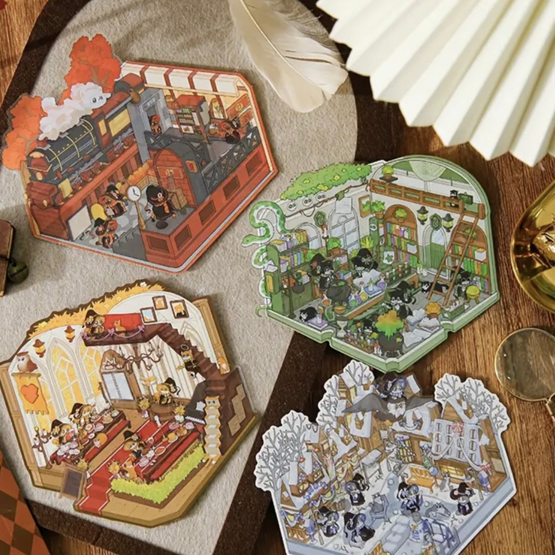 Kawaii miniature fantasy sticker sheets laid out on a table in blue, green, and gold tones