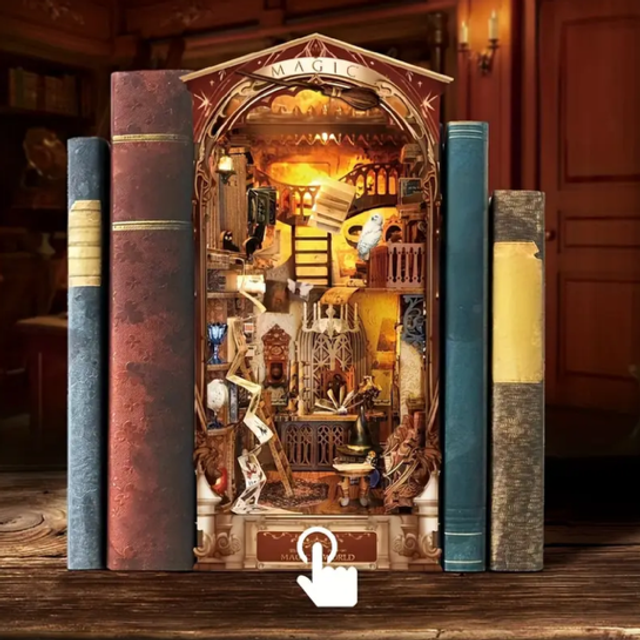 Miniature book nook insert with arched interior scene, set in between three book spines