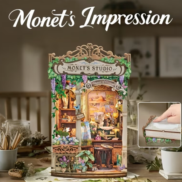 Miniature book nook display with ornate frame and Monet’s Studio banner sign