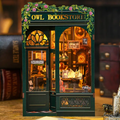 Miniature owl bookstore book nook kit with teal frame and open window display of books