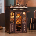 Miniature candy shop book nook kit insert with open shelves and gold “SWEET CHAPTER” sign
