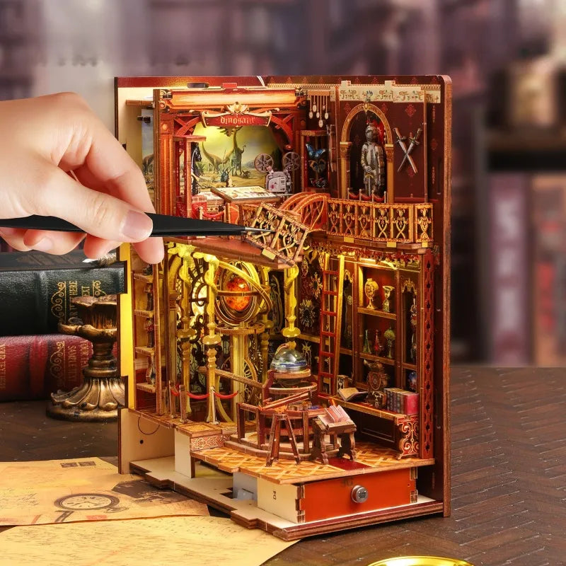 Assembled miniature bookshelf insert kit on tabletop with intricate red-and-gold interior