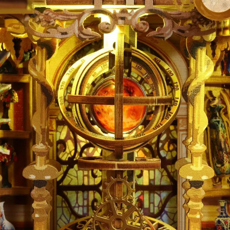 Miniature gold clockwork mechanism inside bookshelf insert kit with circular dial details