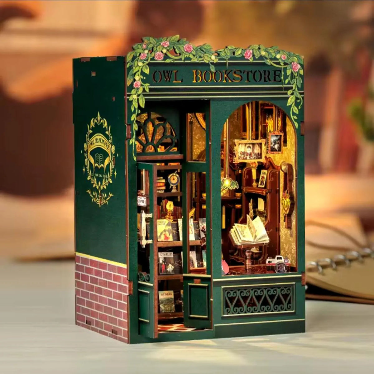 Miniature bookshelf insert DIY kit with teal facade, floral arch, and brick base