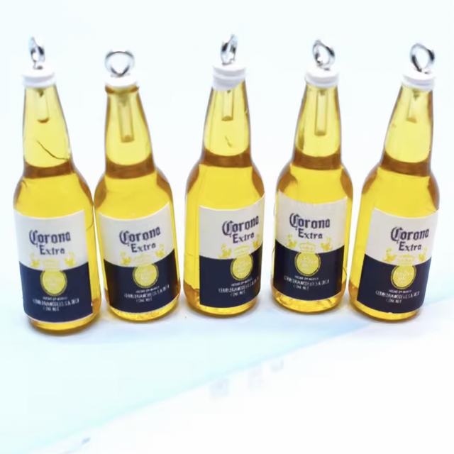 Mini booze bottles with Corona Extra labels, gold caps, standing row