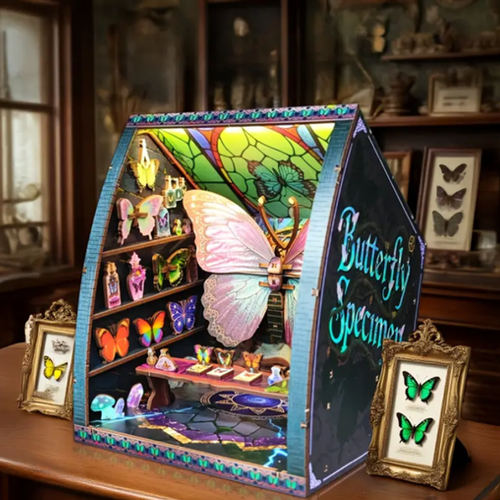 Miniature butterfly specimen book nook display with shelves, butterflies, and opening front
