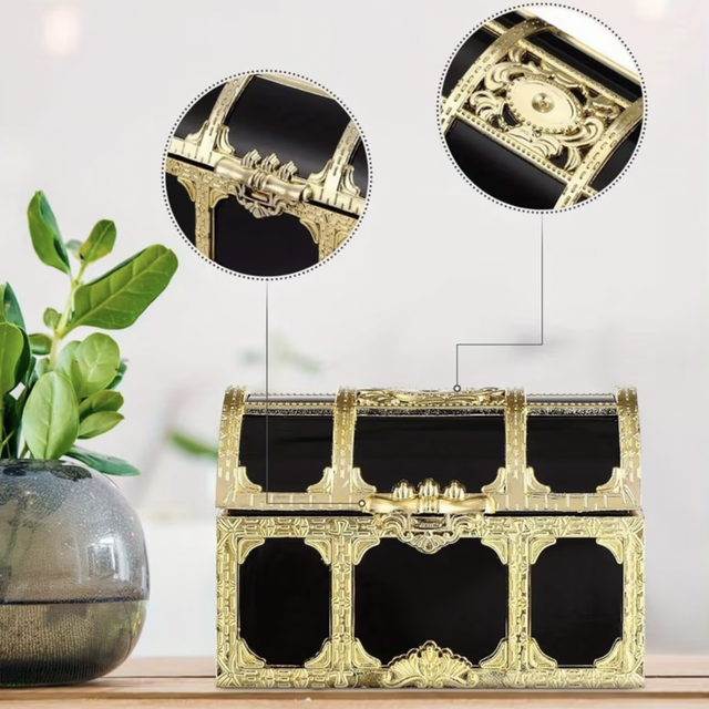 Large decorative treasure chest with ornate gold trim and black interior panels