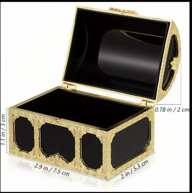 Large treasure chest with open lid, ornate gold details, and black lined interior