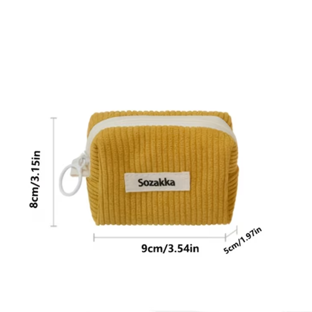 Mustard yellow ribbed zip pouch with small corded handle and Sozakka label
