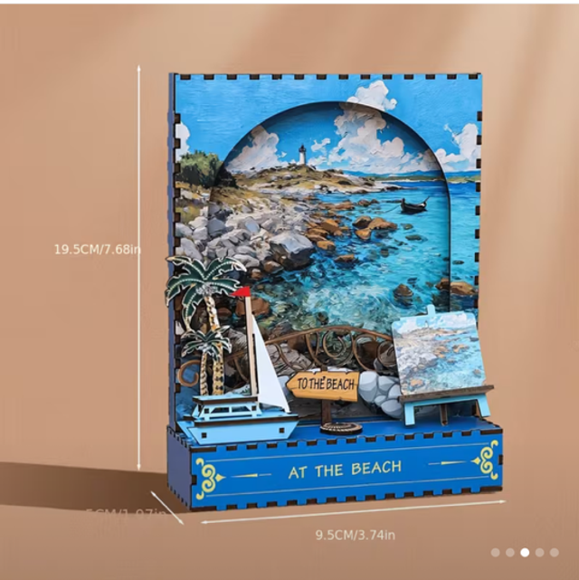 Assembled DIY beach miniature scene with blue frame, sailboat, and “TO THE BEACH” sign