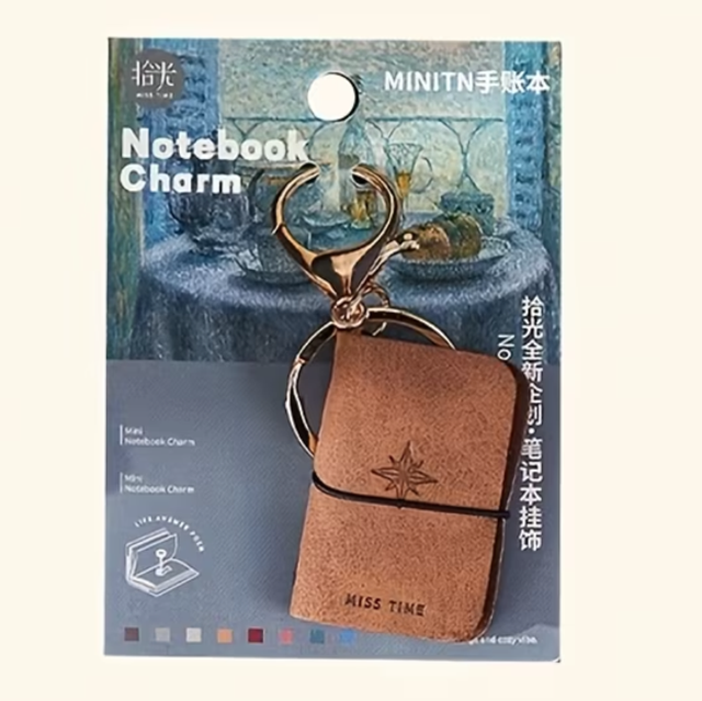 Brown mini notebook keychain charm with gold keyring and clasp, star embossed