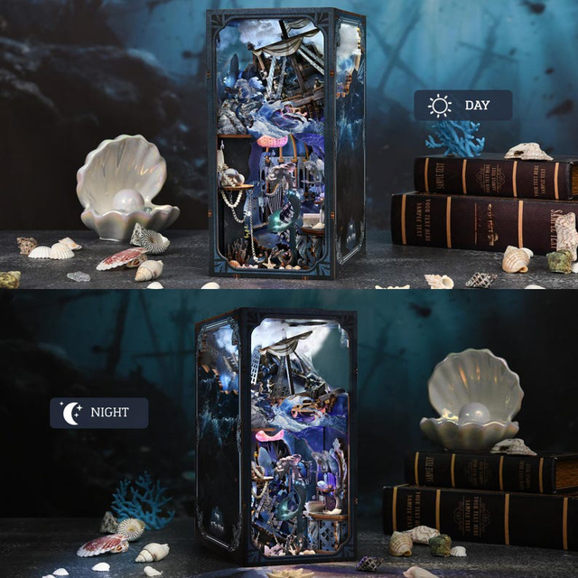 Miniature bookshelf insert diorama with framed door, sea-themed ornaments inside