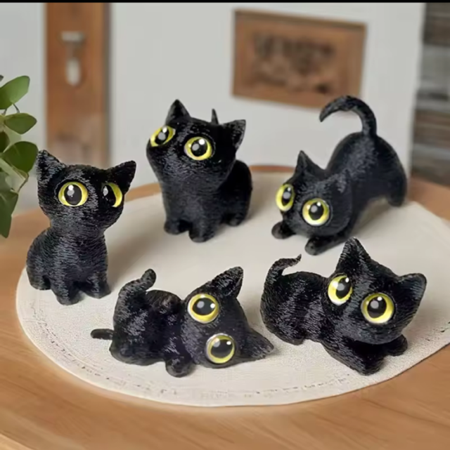 Set of small black cat figurines with yellow eyes