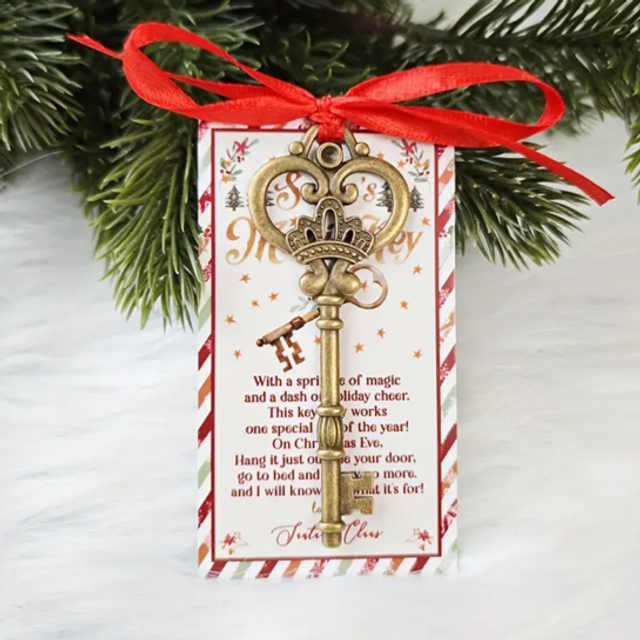 Christmas key ornament with gold key charm, red ribbon bow, on greeting tag