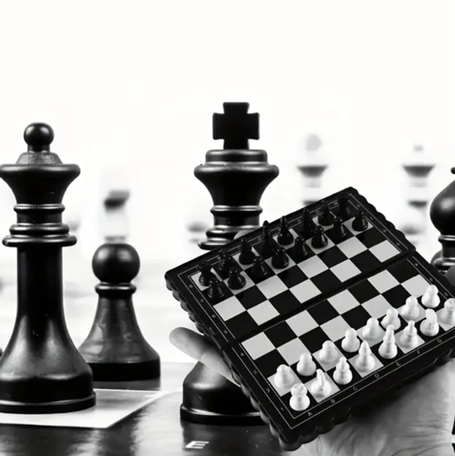 Mini travel chess set with hinged board, black and white pieces
