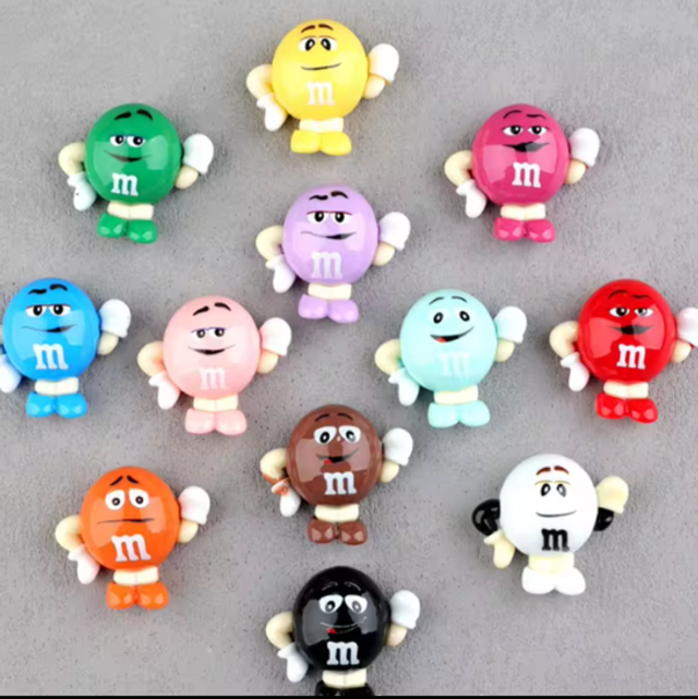 Set of small M&M mini collectible figures, colorful characters with arms at sides