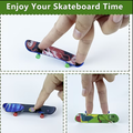 Finger skateboard with colorful graphic deck and green wheels, held by fingers