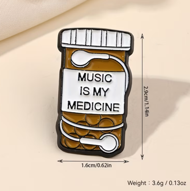 Enamel pill bottle pin badge with 'MUSIC IS MY MEDICINE' text