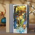 DIY miniature bookshelf insert with colorful fantasy palace scene in a folded display box