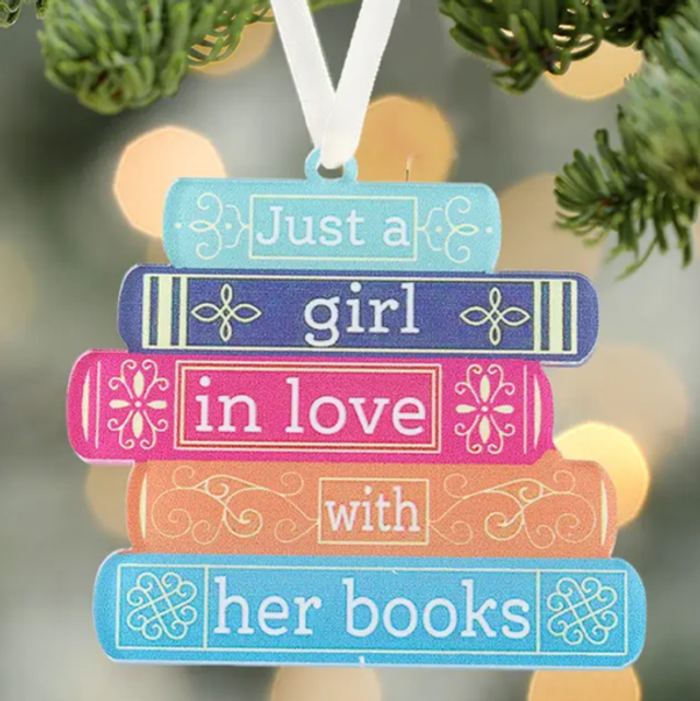 Hanging book-themed sign with stacked text (blue, pink, orange) and white ribbon
