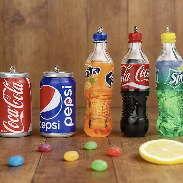 Mini soda bottles with colorful labels, metal caps, and assorted drink colors
