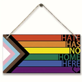 Rainbow wooden hanging sign: 'HATE HAS NO HOME HERE' with heart