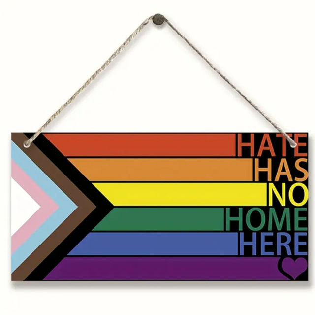Rainbow wooden hanging sign: 'HATE HAS NO HOME HERE' with heart