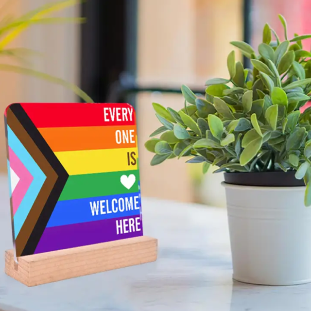 Rainbow 'Every One Is Welcome Here' sign with standing frame and heart icon