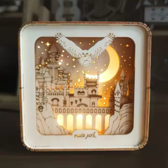 Light-up laser-cut miniature scene box with castle, wings and moon glow inside