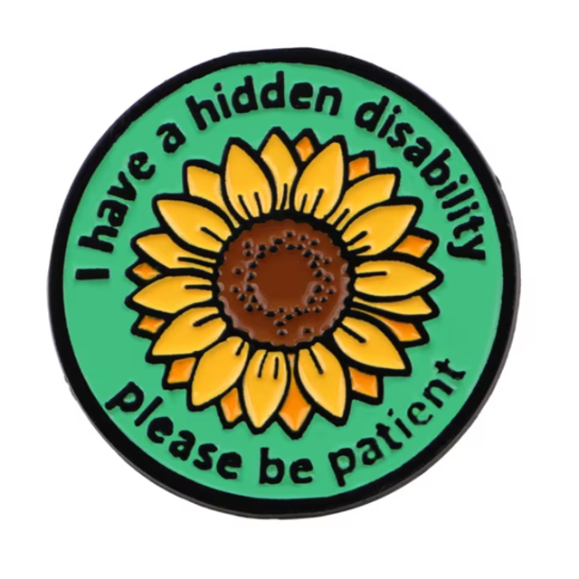 Round green hidden disability pin badge with sunflower and message, black border