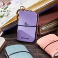Lavender notebook keychain charm with clasp, flower emblem, and 'MISS TIME' text
