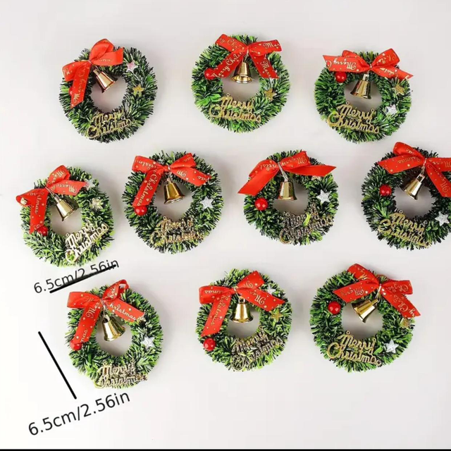 Mini Christmas wreath with evergreen foliage, red ribbon bow, and small gold bell