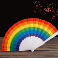 Rainbow fabric folding fan with white pleated panels and handle