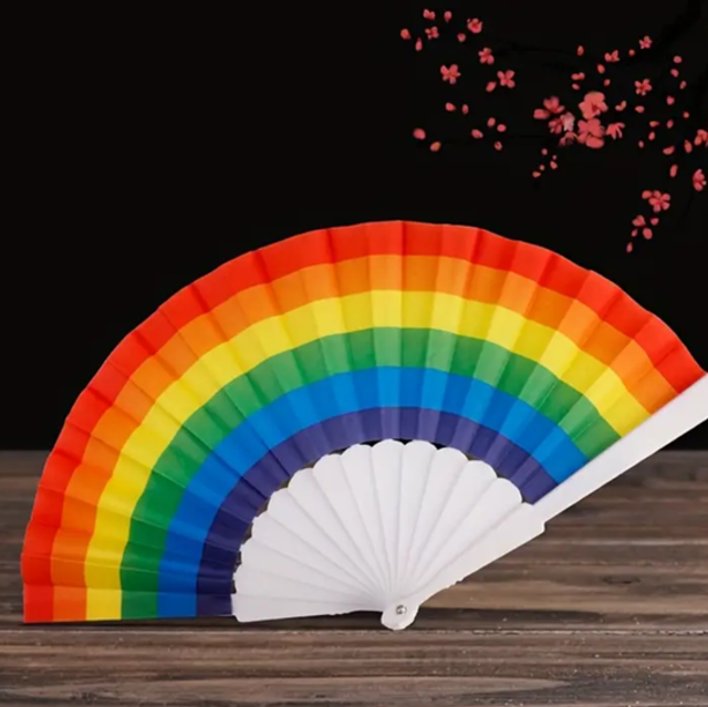 Rainbow fabric folding fan with white pleated panels and handle