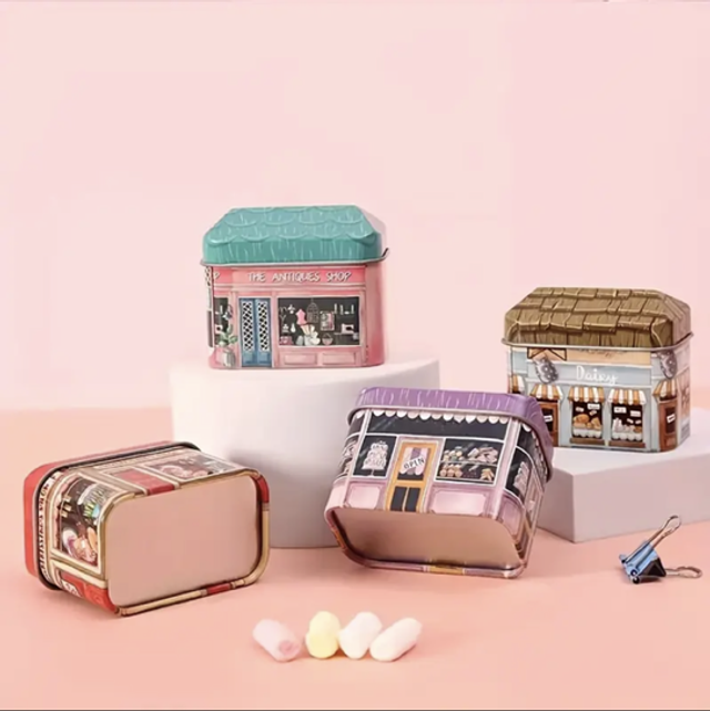 Mini shop storage tin with illustrated storefront, hinged lid and rounded corners, teal top