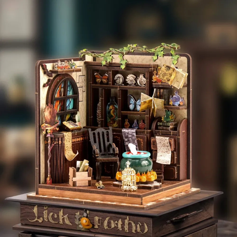 Miniature wooden workshop scene kit with shelves, cauldron, potion bottles, and books