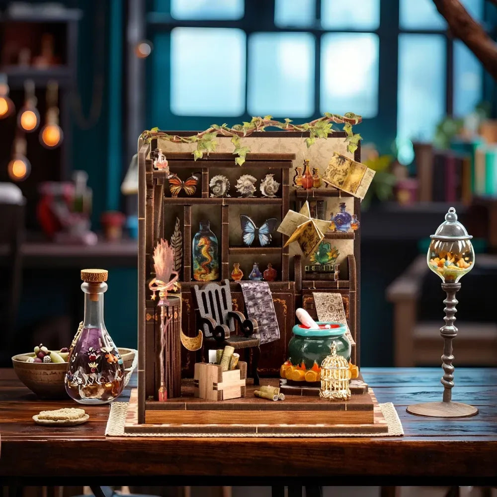 DIY miniature workshop scene kit with potion bottles, butterfly display, and open book props